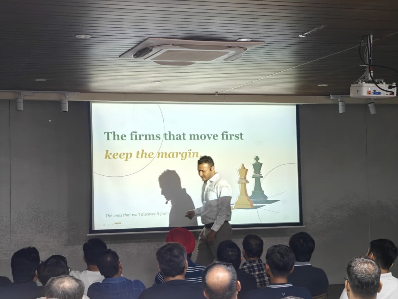 Jigar Joshi walking the stage during the AIMED Agentic Operating System workshop for software CEOs in Ahmedabad
