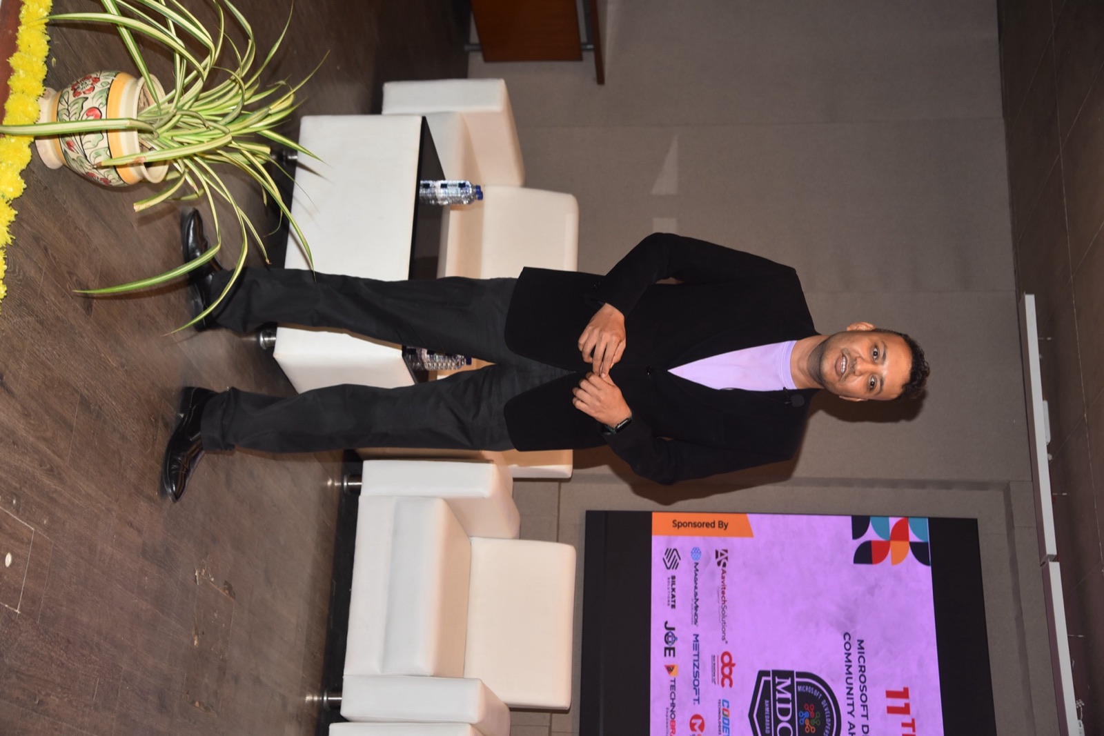 Jigar Joshi standing on stage between sessions at 11th DOT NET DAY, MDCA Ahmedabad