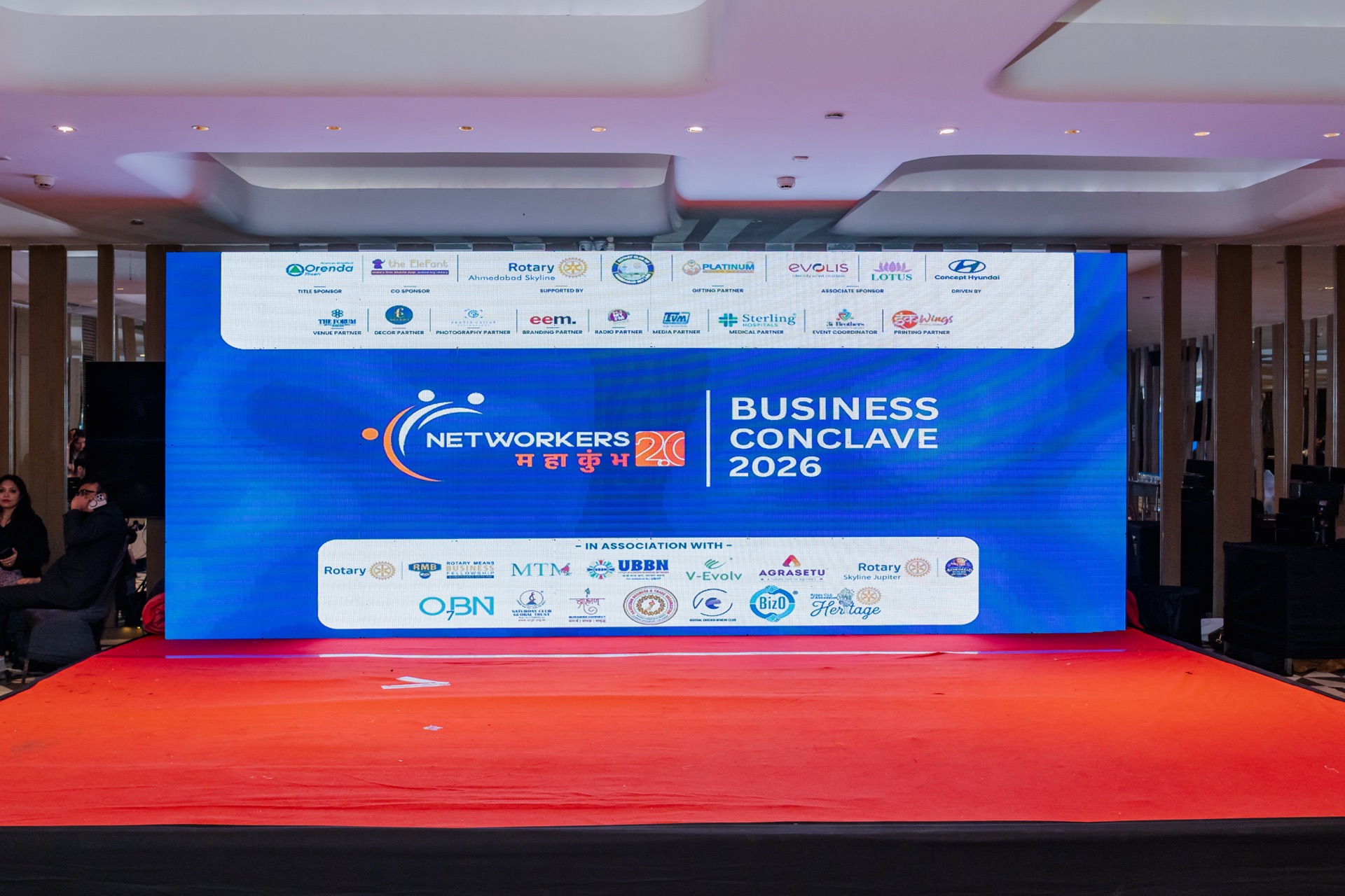 Networkers Mahakumbh 2.0 Business Conclave 2026 stage backdrop with sponsor logos at The Forum, Club 07, Ahmedabad