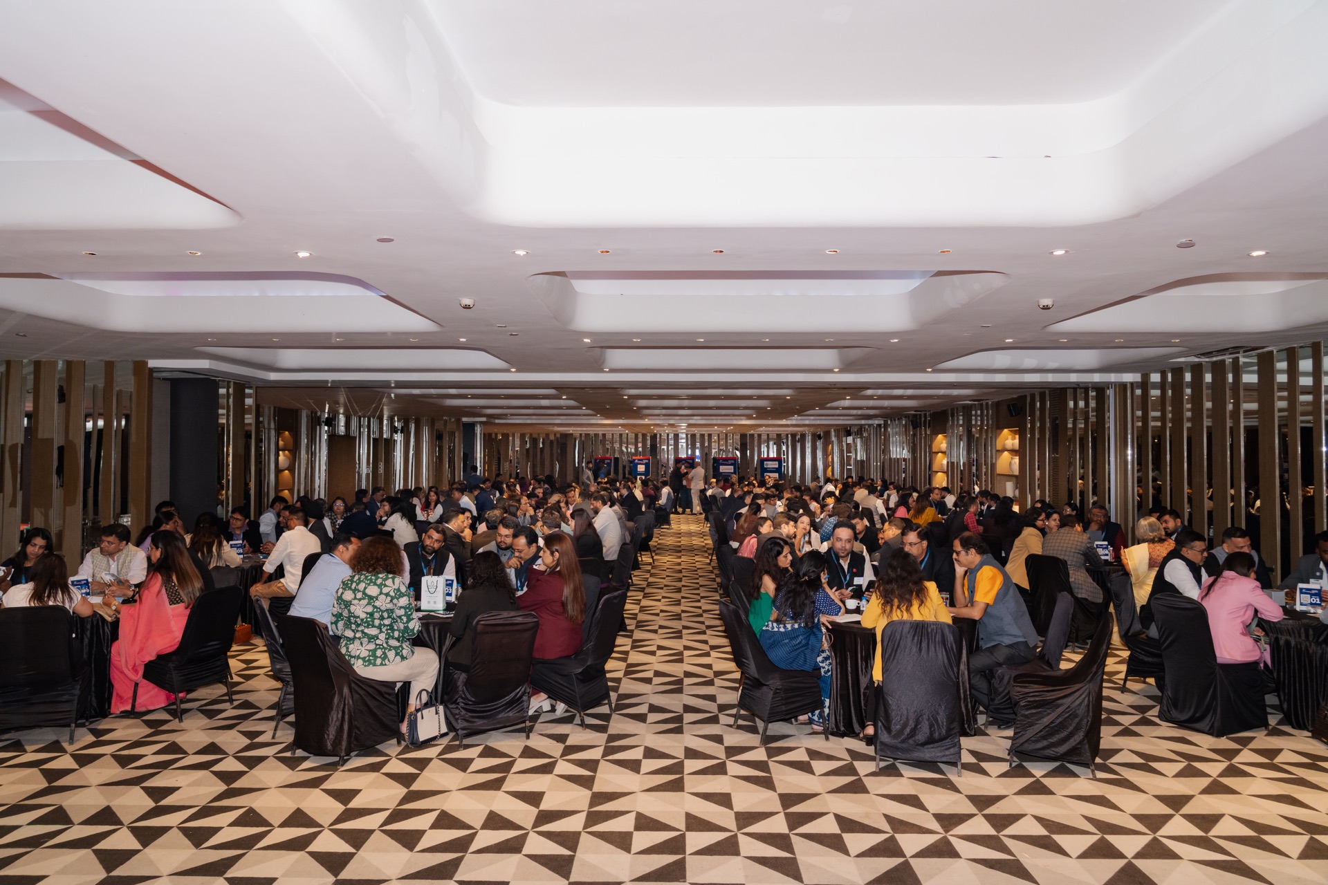 Wide ballroom view of attendees networking in groups at Networkers Mahakumbh 2.0 Business Conclave 2026